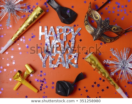 Happy New Year Party Decorations on festive orange wood table. 