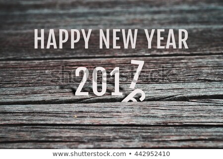 Celebrate Happy New Year 2017, coming to replace 2016. Abstract background for new year 2017 celebration, alphabet number paper character on grunge retro wood panel background, vintage style.