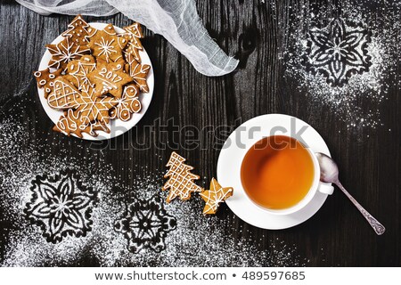 Christmas gingerbread and cup of tea with snowflakes decorations
