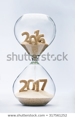 New Year 2016 concept with hourglass falling sand taking the shape of a 2017