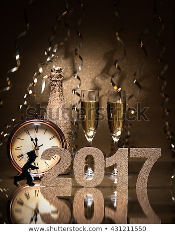 New Years Eve celebration background with pair of flutes, bottle of champagne, clock and a chimney sweep as lucky charm